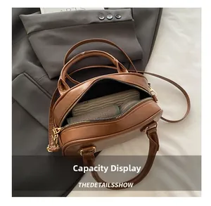 Aperçu de la capacité intérieure d'un sac Boston en cuir PU marron avec détails dorés