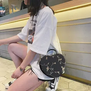Elegant heart-shaped crossbody bag with floral embroidery and golden chain strap