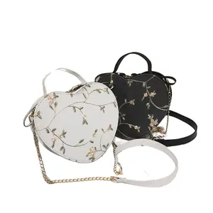 Fashion heart shaped crossbody bag with floral embroidery in black and white colors