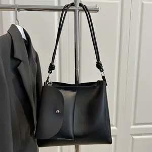 Minimalist black faux leather tote bag set with knot shoulder strap and small pouch
