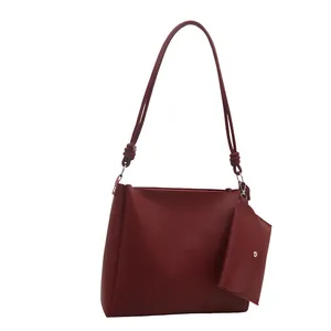 Vintage burgundy PU leather bucket shoulder bag with matching coin purse on white background