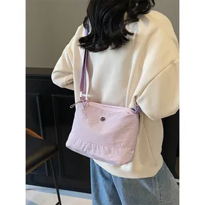 Lavender nylon crossbody bag with adjustable strap shown on model for casual daily wear