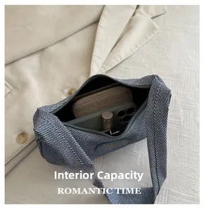 Internal capacity of the blue denim half-moon shoulder bag with phone and lipstick