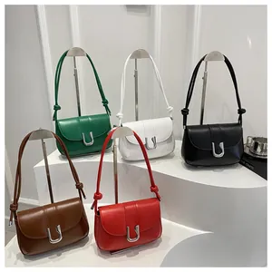 Five minimalist matte leather handbags with U-shaped buckles and knotted strap detail