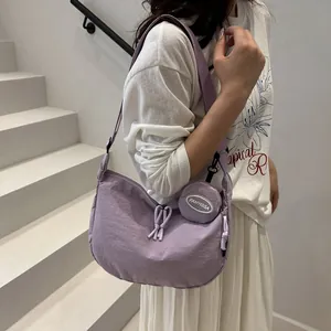 Lavender nylon crescent tote bag with round coin purse and thick woven strap