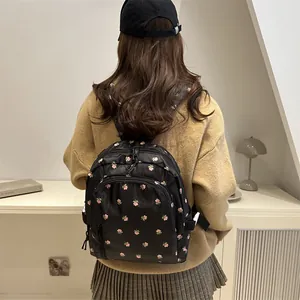 Stylish black floral backpack for women featuring waterproof nylon and large capacity