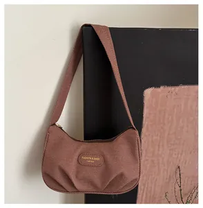 Detailed texture of dark brown pleated hobo bag with retro fabric and metal tag