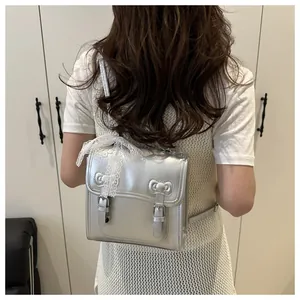 Detail of silver metallic PU backpack with twin bows and lace ribbon on back