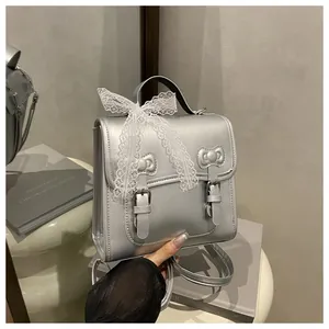 Detail view of silver PU leather backpack with lace bows and adjustable metal buckles