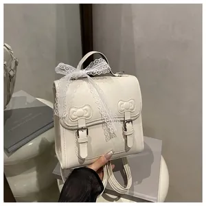 Detail of cream-white PU leather backpack with embossed bows and lace ribbon trim
