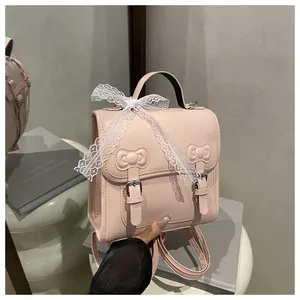 Detail of pink PU leather backpack with decorative bows and white lace ribbons