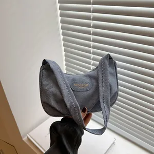 Minimalist blue denim textured pleated underarm bag for women with modern crescent shape