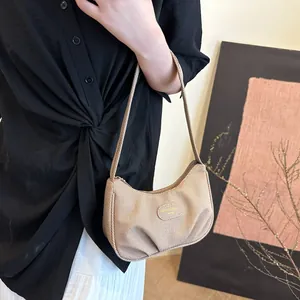 Minimalist pleated woven underarm shoulder bag in khaki with metallic brand logo accent