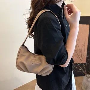 Pleated khaki hobo shoulder bag with textured fabric and leather logo patch