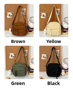Four colors of corduroy crossbody bags with plush charms and woven drawstring detail