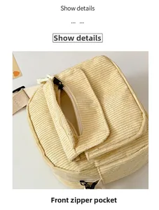 Detail view of the yellow corduroy crossbody bag showing the front zipper pocket