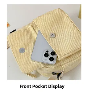 Detailed front pocket view showing storage capacity for a smartphone in corduroy bag