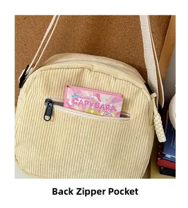 Detail of corduroy crossbody bag featuring a back zipper pocket and high-quality texture