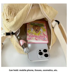 Internal view of yellow corduroy crossbody bag showing capacity for daily essentials