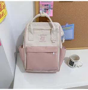 Close-up of the cream white and pink backpack featuring delicate ice cream embroidery detail