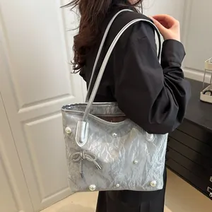 Silver pleated tote bag with pearl trim and rhinestone bow, stylish underarm shoulder bag