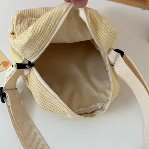 Fashionable beige corduroy crossbody bag for women with adjustable strap and zip closure
