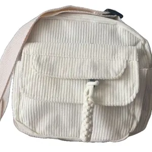 Minimalist beige corduroy crossbody bag with textured stripes and woven rope detail