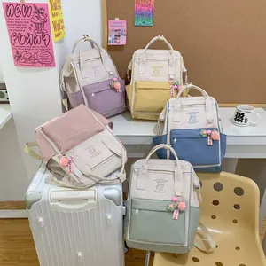 Lightweight waterproof canvas backpack for women in multiple soft colors with cute charms