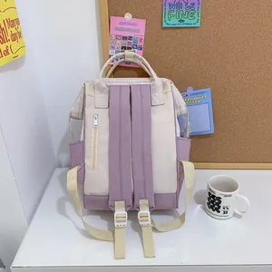 Lightweight cream and purple waterproof mini backpack with multi-pocket design for women