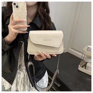 Detail of cream leather and canvas crossbody bag with geometric wide shoulder strap