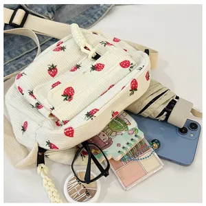 Corduroy crossbody bag interior view showing space for phone, umbrella, and makeup