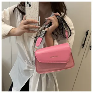 Pink leather shoulder bag detail with FASHION & BAGS text and checkerboard strap