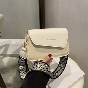Cream square crossbody bag with wide jacquard strap and gold fashion lettering