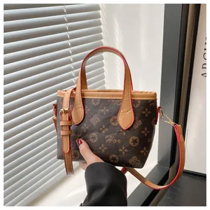 Detailed shot of retro monogram bucket bag with red edge paint and gold metal hardware