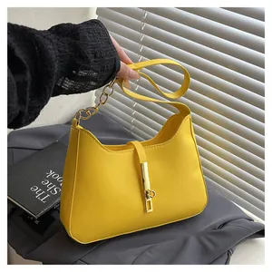 Minimalist yellow PU leather underarm bag with gold chain strap and metal lock detail