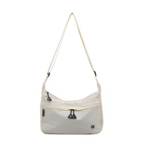 Sac bandoulière en nylon crème avec sangle réglable et tirettes de zip triangulaires