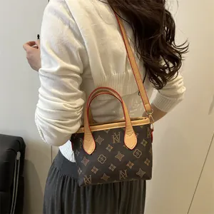 Classic monogram tote bucket bag with vintage brown leather trim and dual handles
