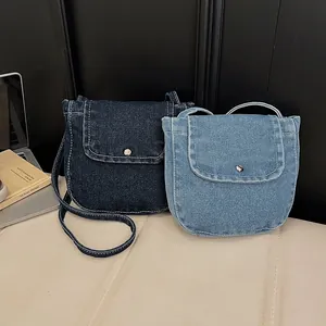 Retro denim shoulder bags in light and dark blue with contrast stitching and metal snaps