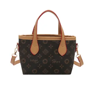 Classic brown monogram bucket tote bag with red-edged handles and star pattern details