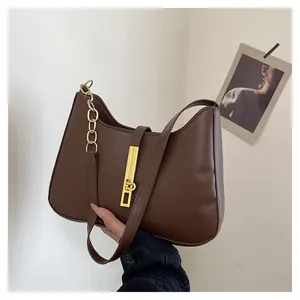 Deep brown matte leather half-moon underarm bag with elegant gold metal buckle