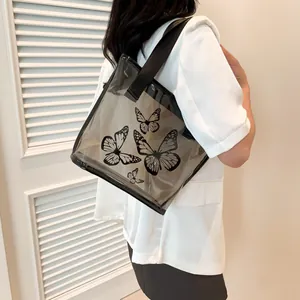 Minimalist transparent PVC tote bag with black butterfly print and fabric shoulder straps