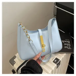 Chic light blue faux leather shoulder bag with a gold lock and chain strap
