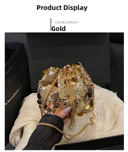 Detailed shot of golden sequin bucket bag with pearl drawstring and metal chain strap