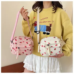 Pink and white corduroy crossbody bag with strawberry print and adjustable strap for women