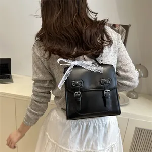Chic black PU leather backpack with bows and lace detail shown on a model for daily use
