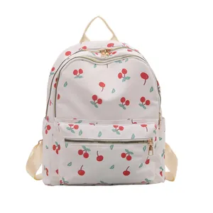 Off-white backpack with red cherry print and gold metal zippers for women students