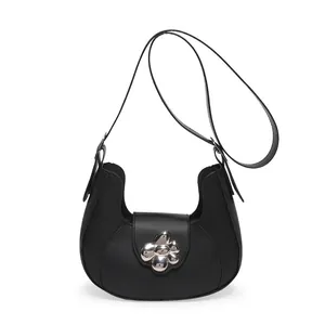 Minimalist black half-moon crossbody bag featuring a large silver metallic flower buckle