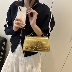 Luxurious gold crossbody bag with crocodile texture and elegant metal chain strap