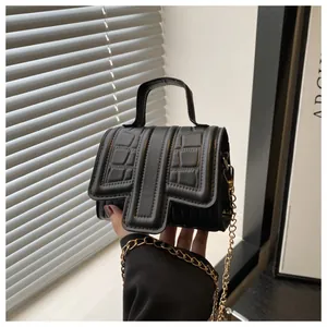 Chic black crocodile embossed small square bag with elegant gold chain shoulder strap