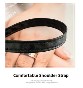 Detail of comfortable black leather shoulder strap with durable reinforced stitching